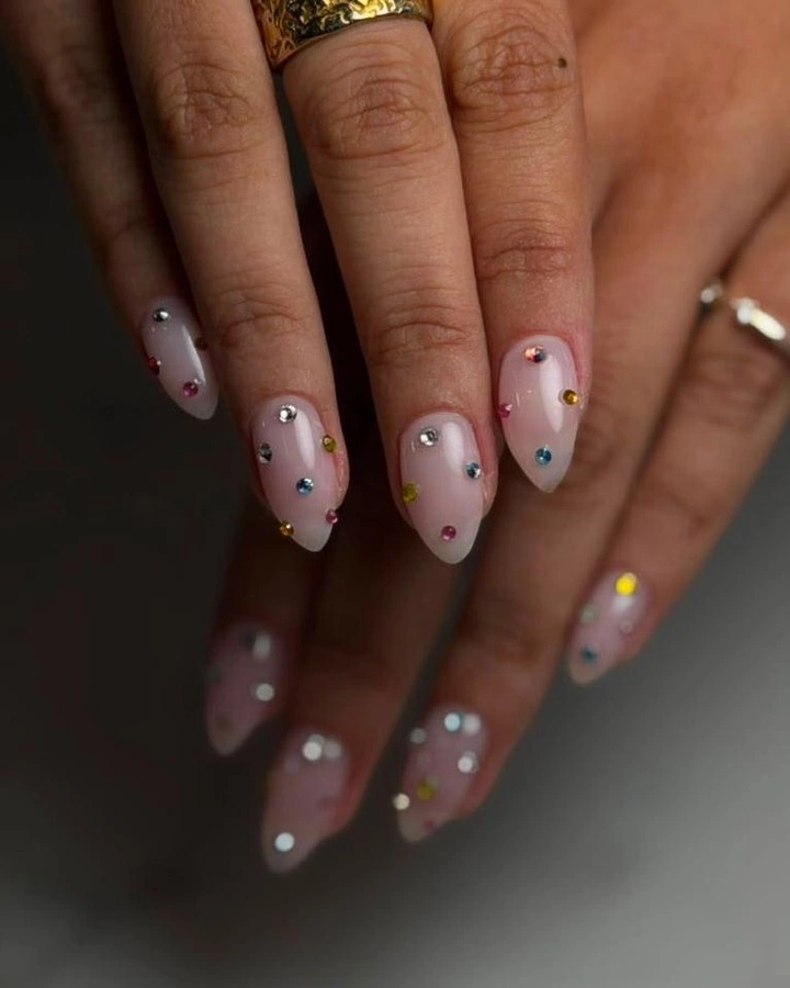 Medium nude almond nails with colorful French tips and tiny dots
