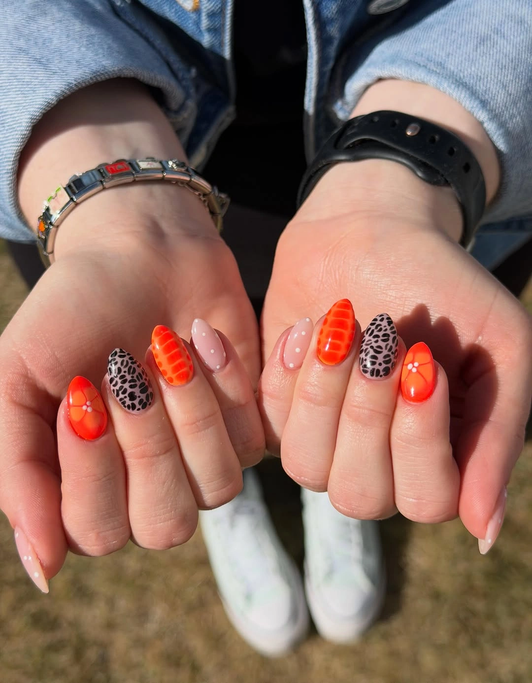 Long charcoal almond nails with subtle brown organic line patterns