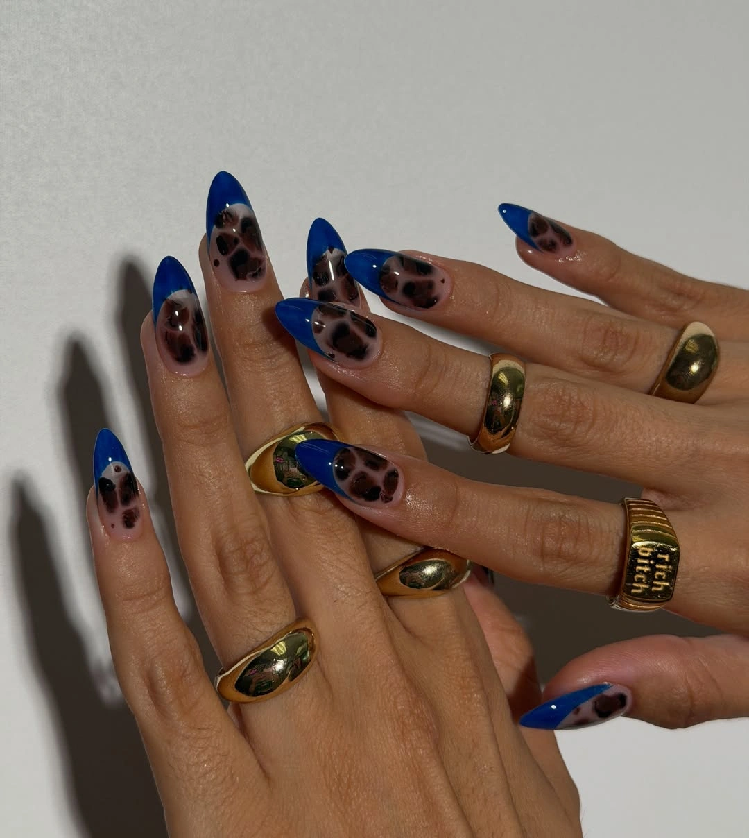 Short rounded nails with black white tips and fine nude graphic details