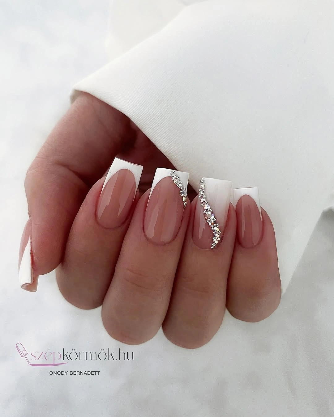 Short almond blush wedding nails with delicate silver crystal side accents