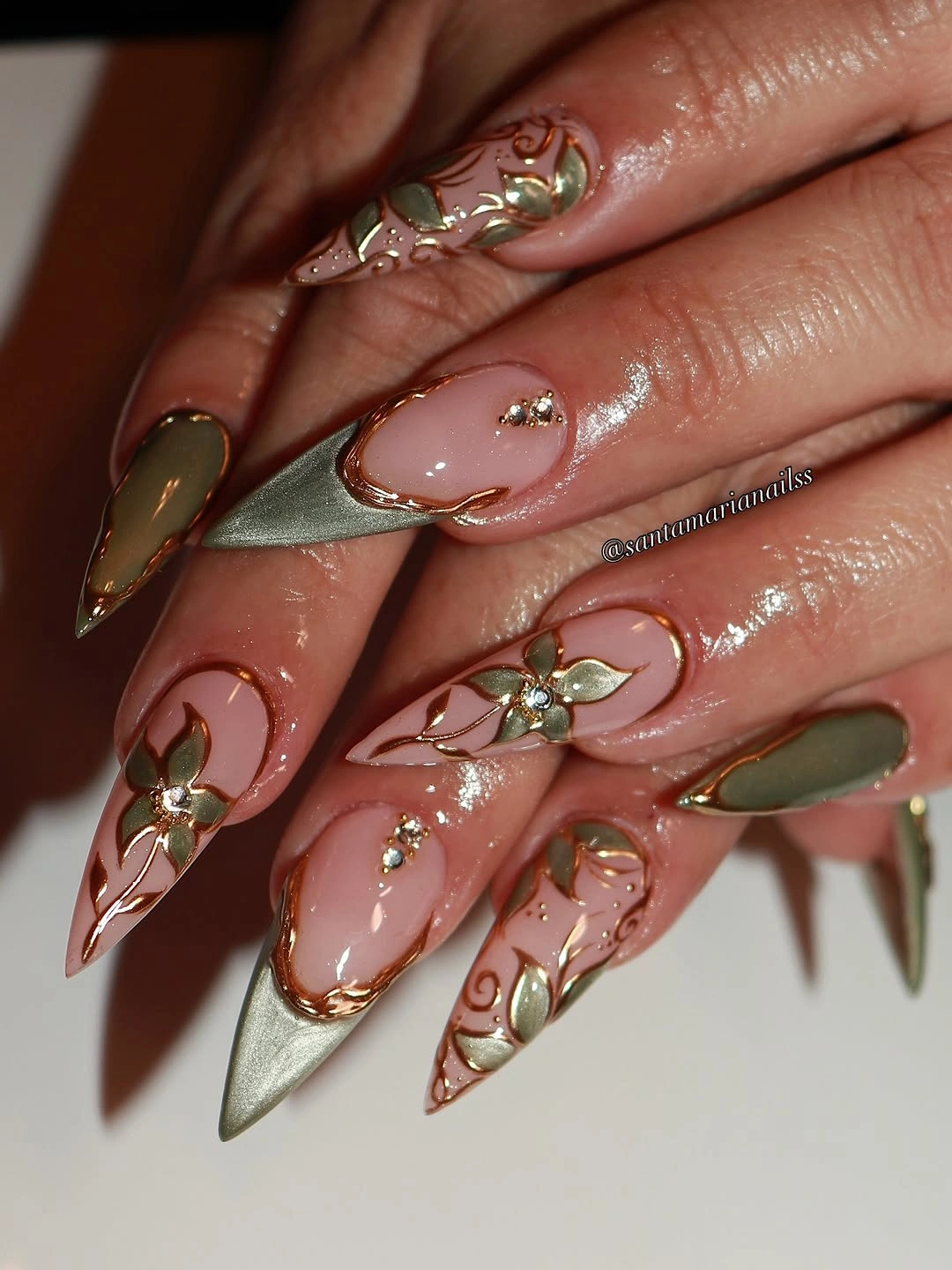 Long blush pink and olive almond nails with raised gold botanical details