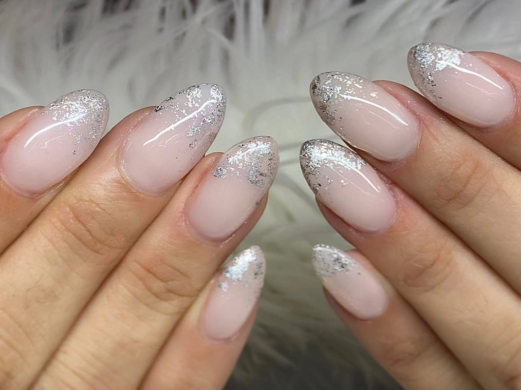 Milky pink almond wedding nails with delicate silver glitter French tips
