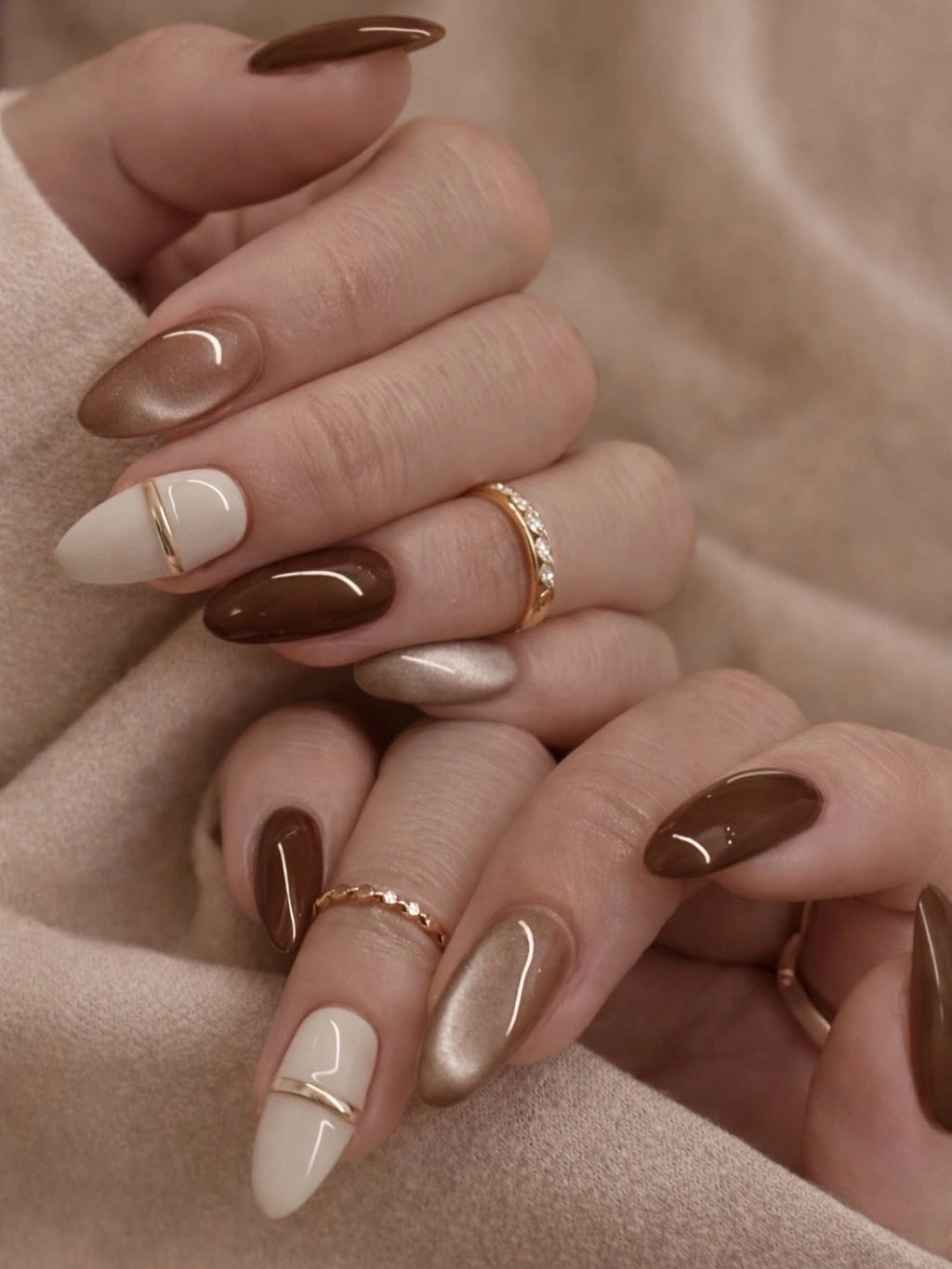 Short almond wedding nails in chocolate brown taupe and cream with curved accents