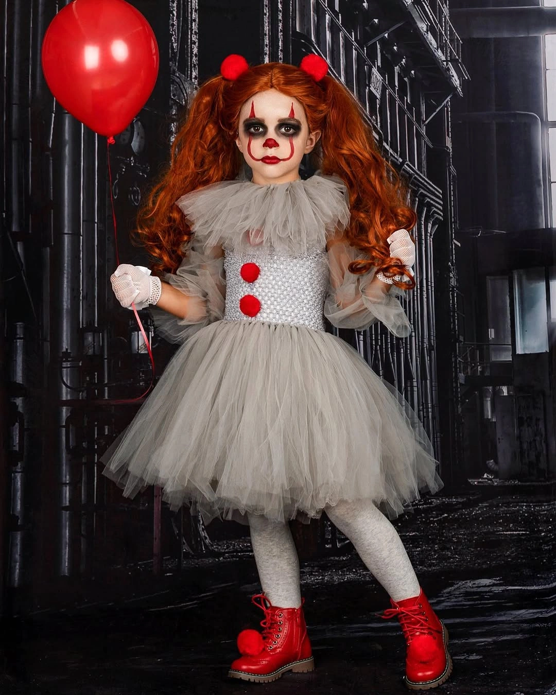 Pennywise from IT costume with gray ruffled dress red pom-poms red boots pigtails and red balloon