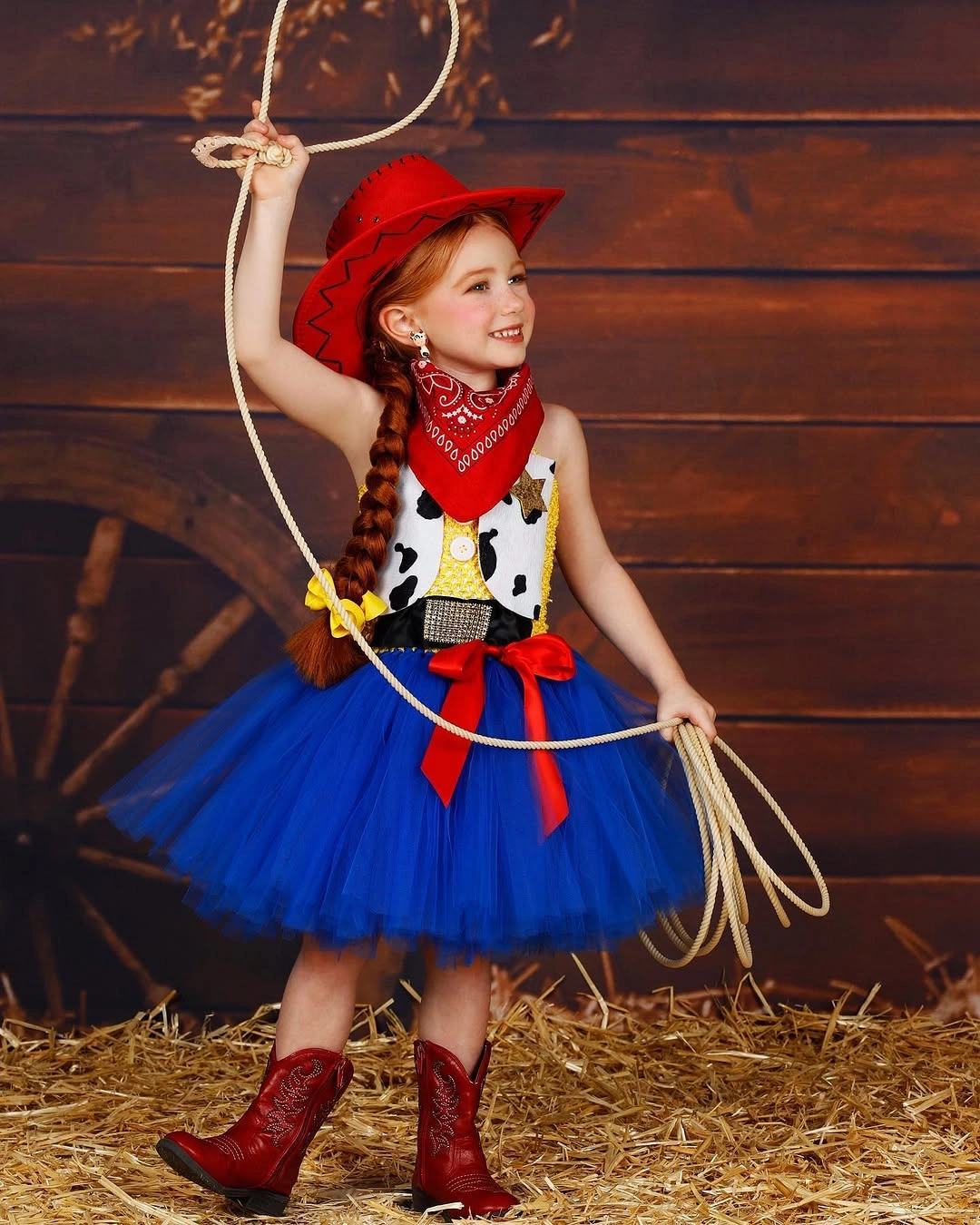 Jessie from Toy Story child costume with red cowgirl hat bandana cow-print vest blue skirt red boots and lasso