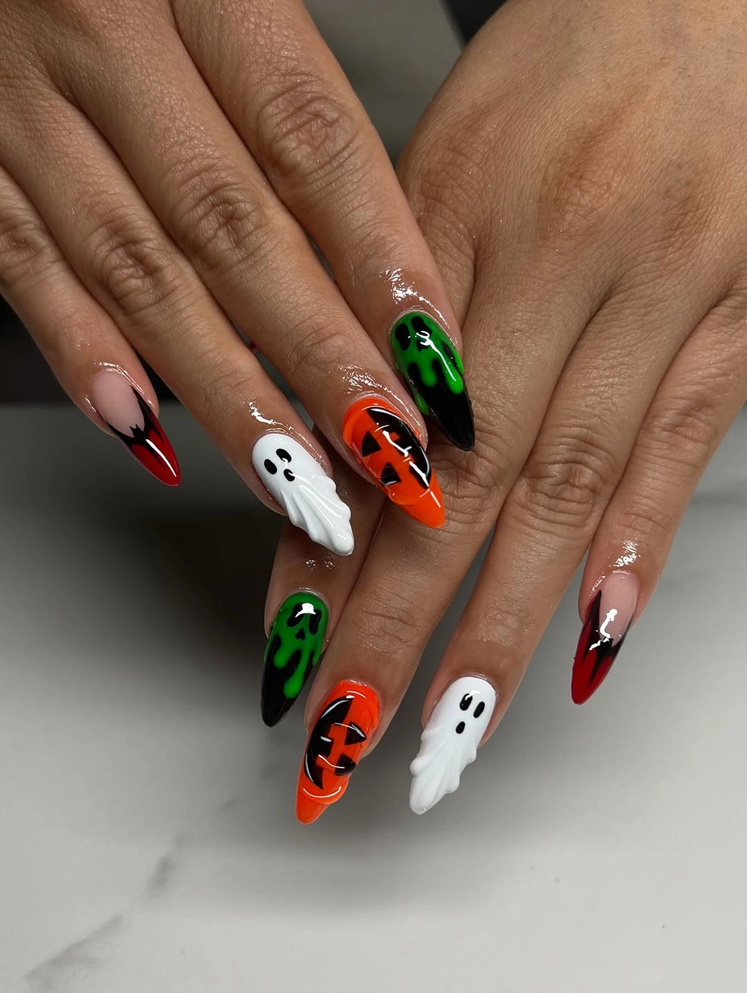 Medium almond black white orange and green Halloween nails with figures