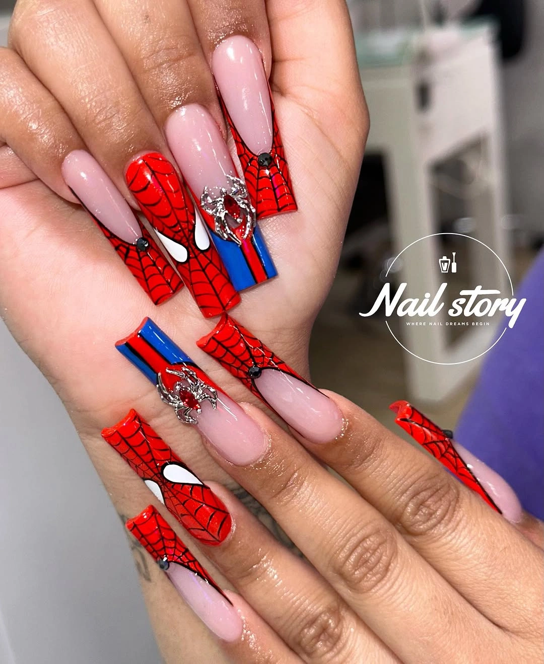 Long square pale pink nails with red blue and white web graphics