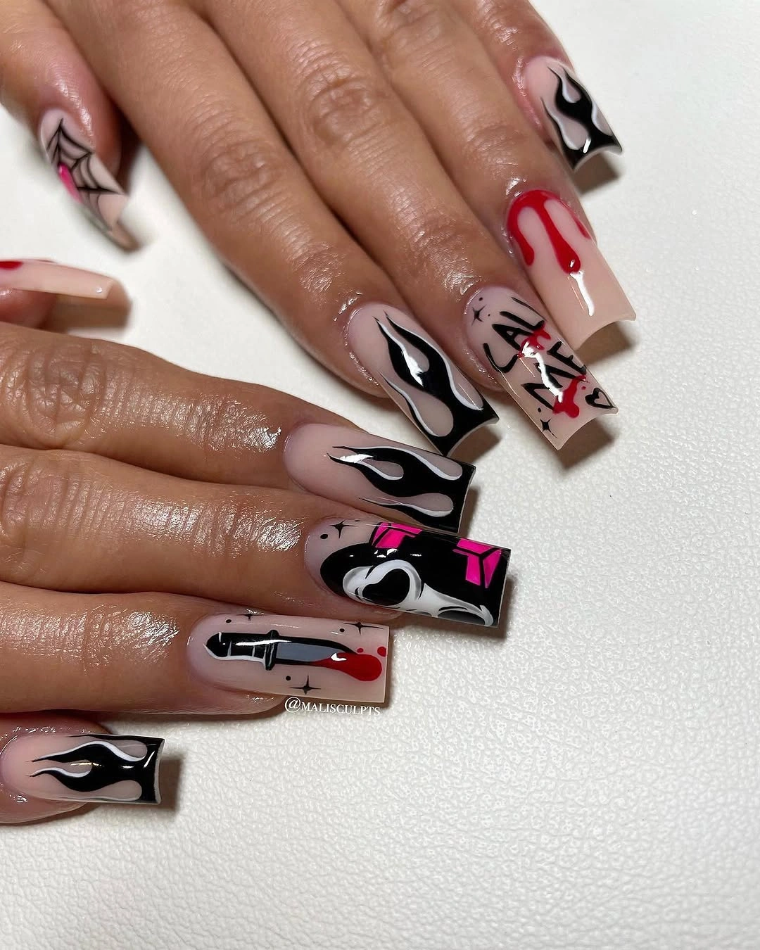 Long coffin pale pink nails with dripping and web-like Halloween lines