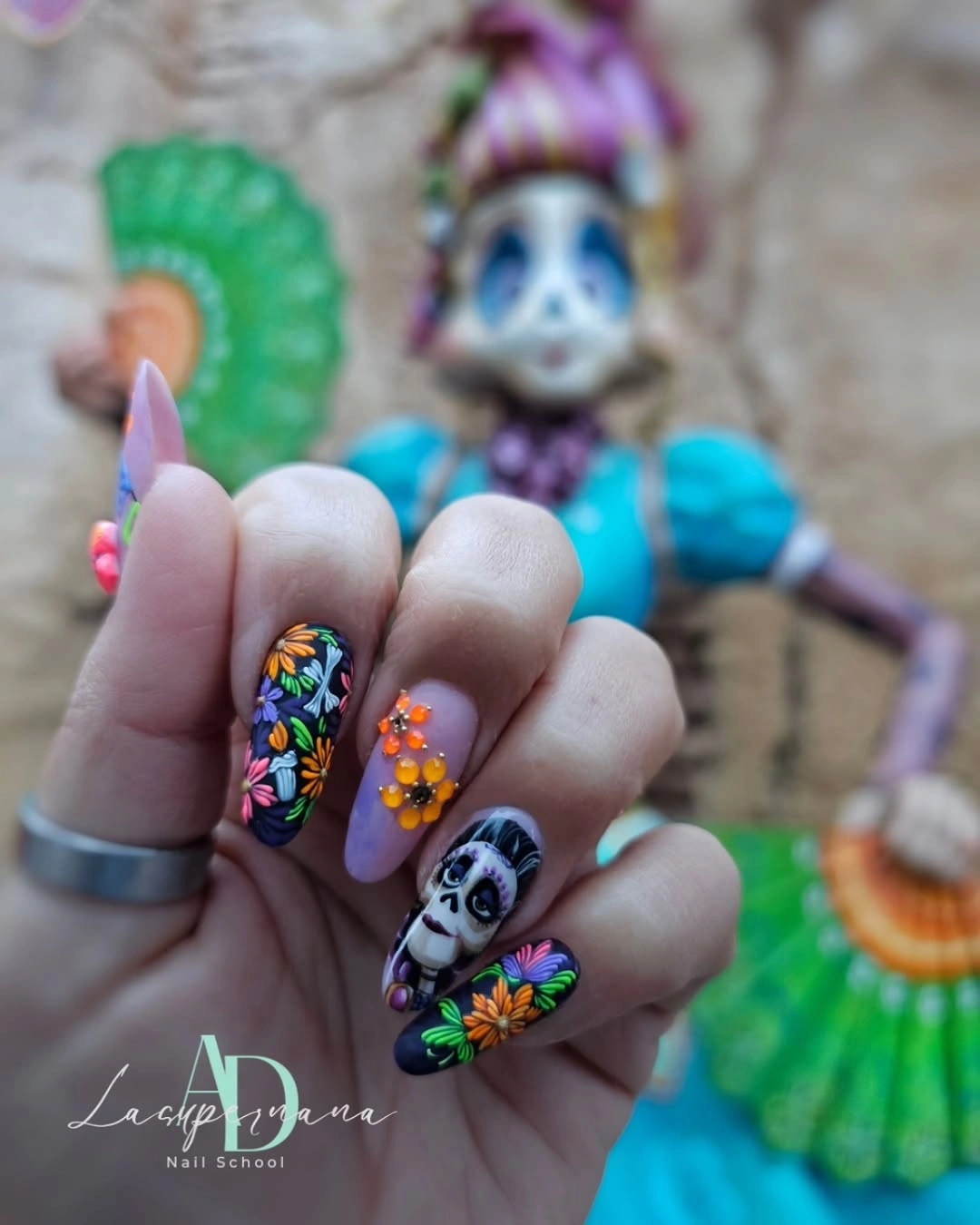 Short pastel blue and nude nails with colorful Halloween character accents
