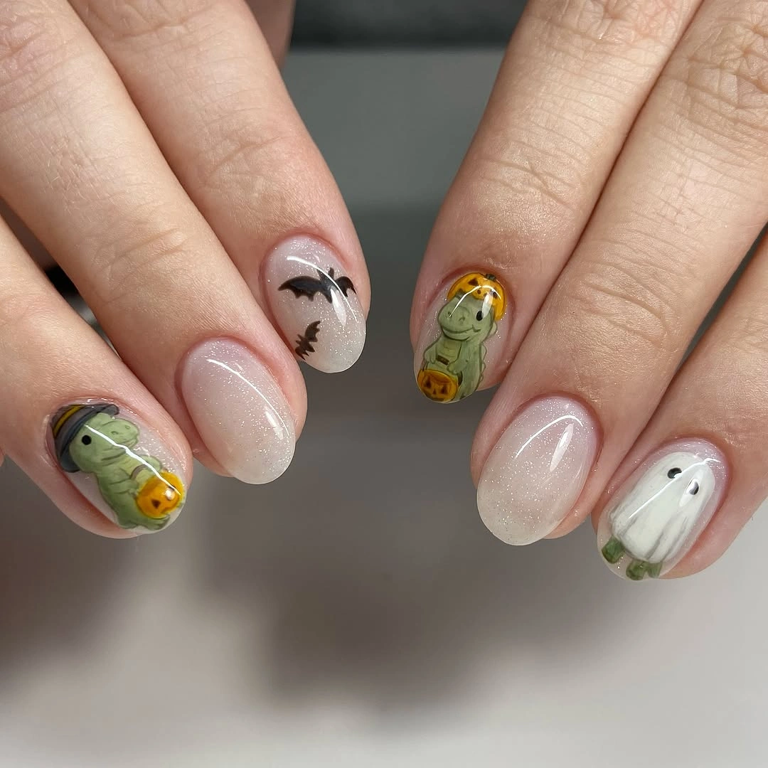 Short white pink and pale green nails with tiny Halloween accents