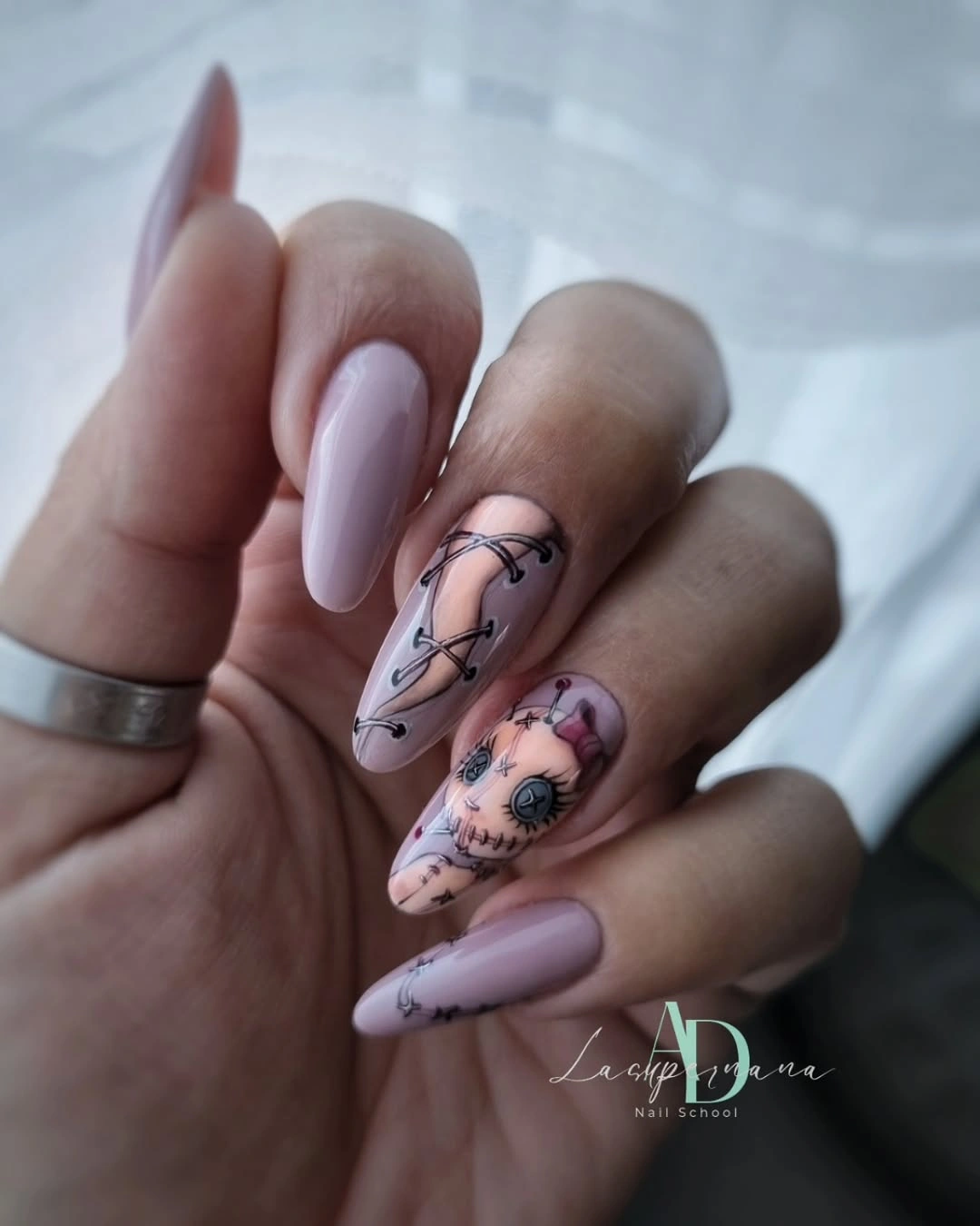 Medium almond lavender pink nails with orange Halloween illustrations