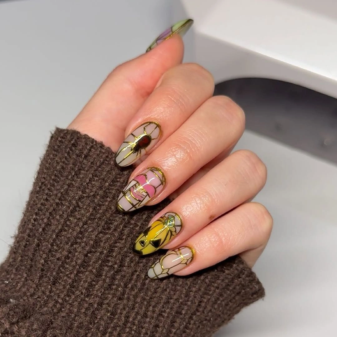 Long nude almond nails with tiny black green and reflective details