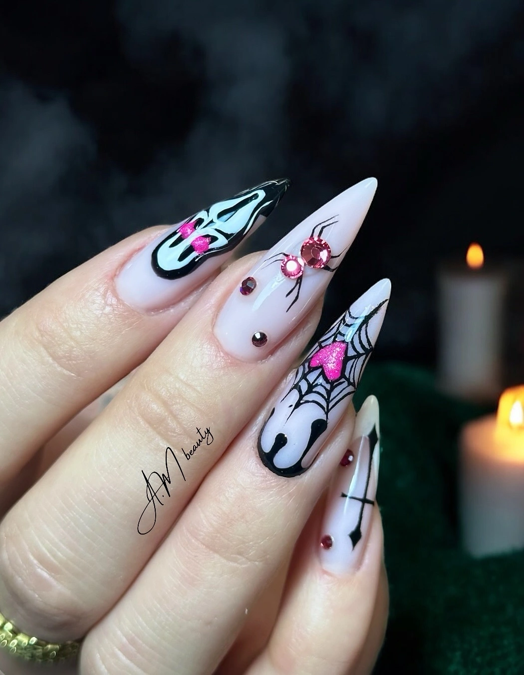 Long pale pink almond nails with black and hot pink Halloween art