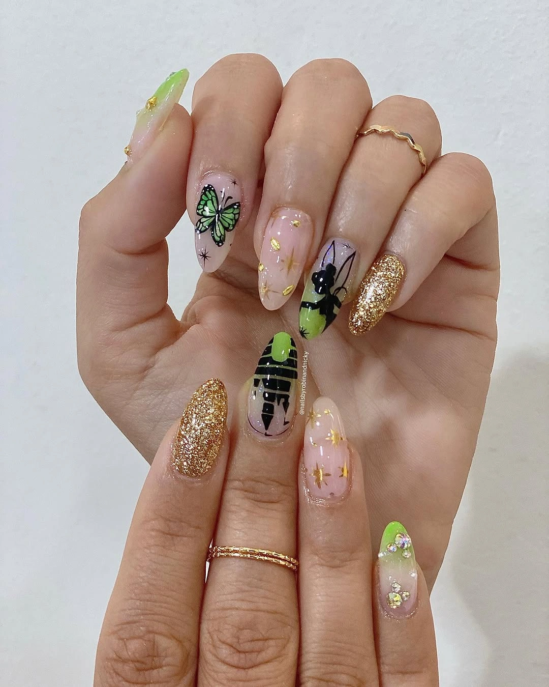 Pale almond nails with neon green accents glitter and spooky details