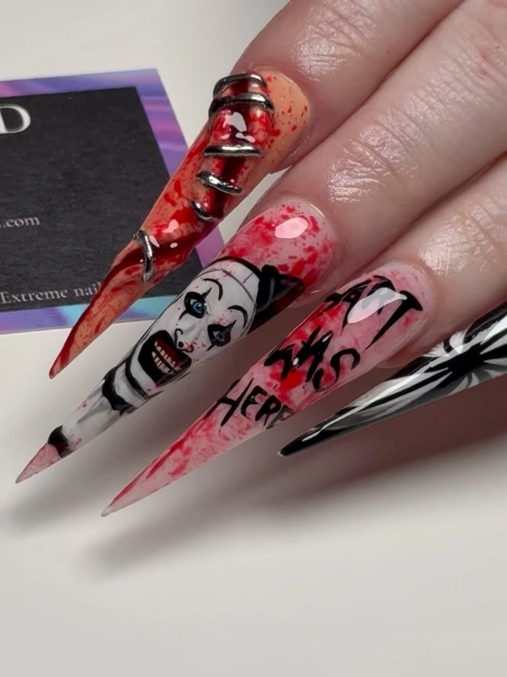 Very long stiletto nails with red black white and pink graphic panels