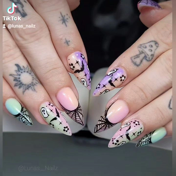 Long pastel almond nails with outlined ghosts and delicate Halloween art