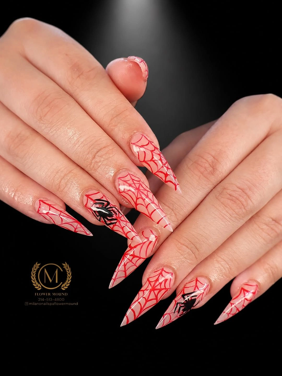 Long red and pink stiletto nails with white web-like graphics