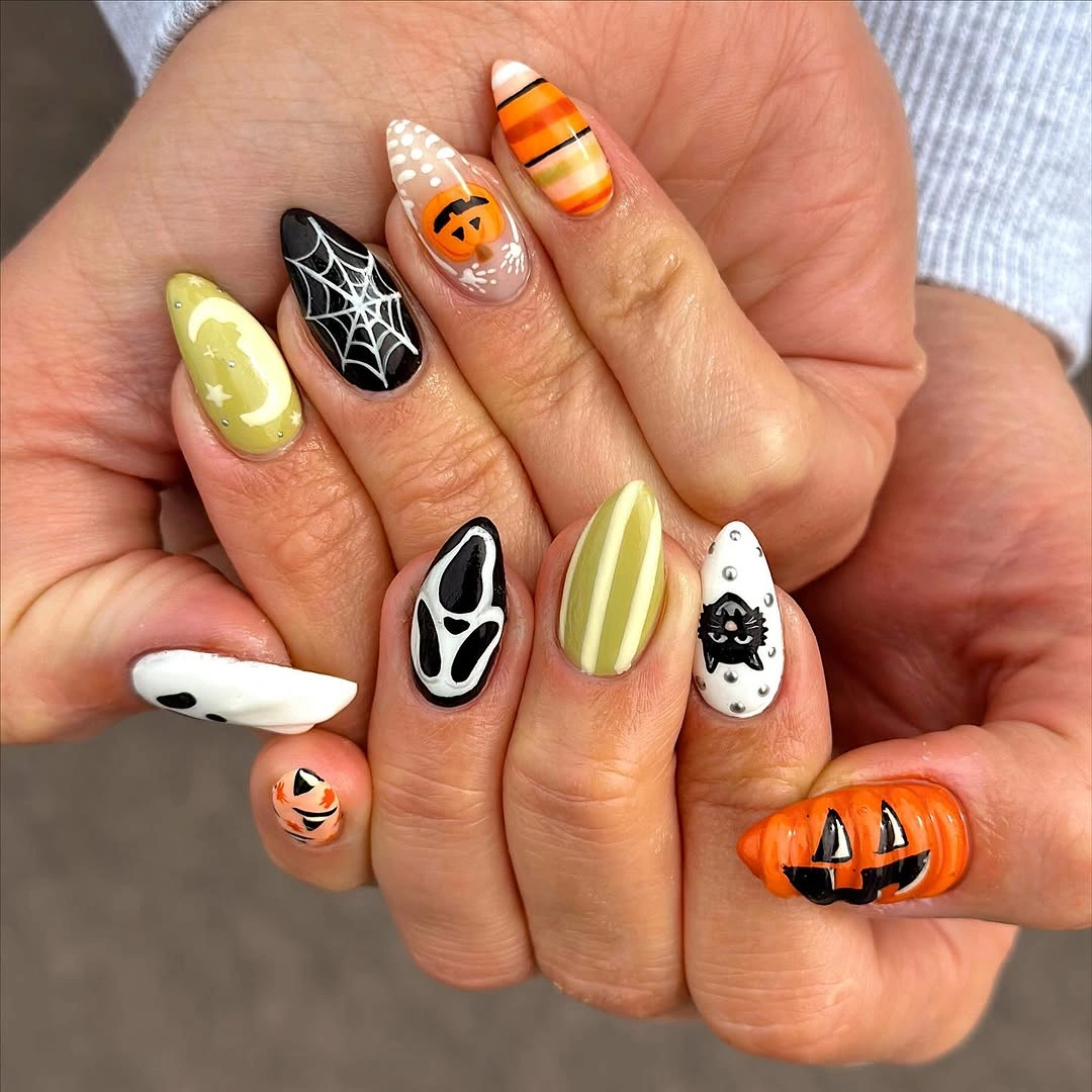 Medium almond yellow nails with colorful ghost and pumpkin figures