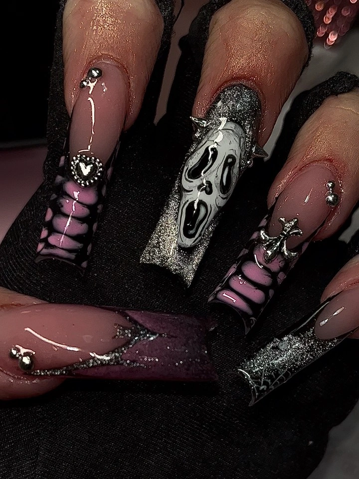 Long smoky stiletto nails with purple black spider-like embellishment