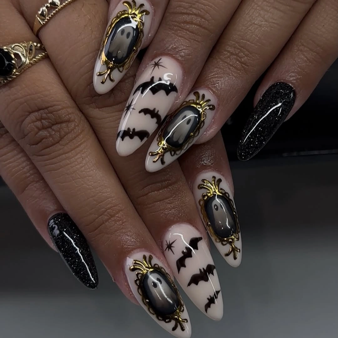 Long nude almond nails with black silhouettes and web-like lines