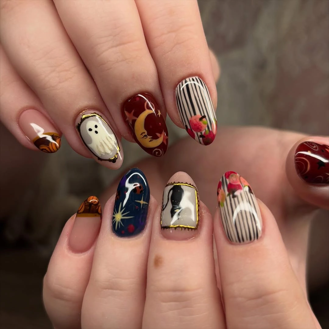 Medium almond nude nails with striped and illustrated Halloween panels