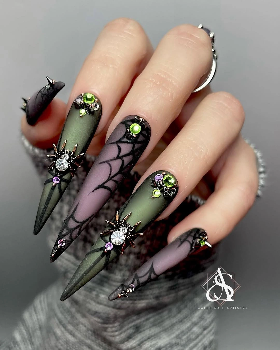 Long stiletto black gray nails with neon green accents and webs