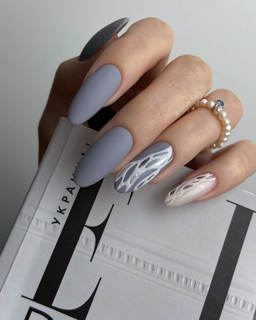 Cool gray lavender almond nails with pale leaf line art accents