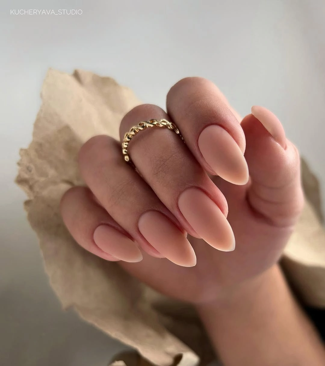Nude almond nails with fine muted burgundy curved contour lines