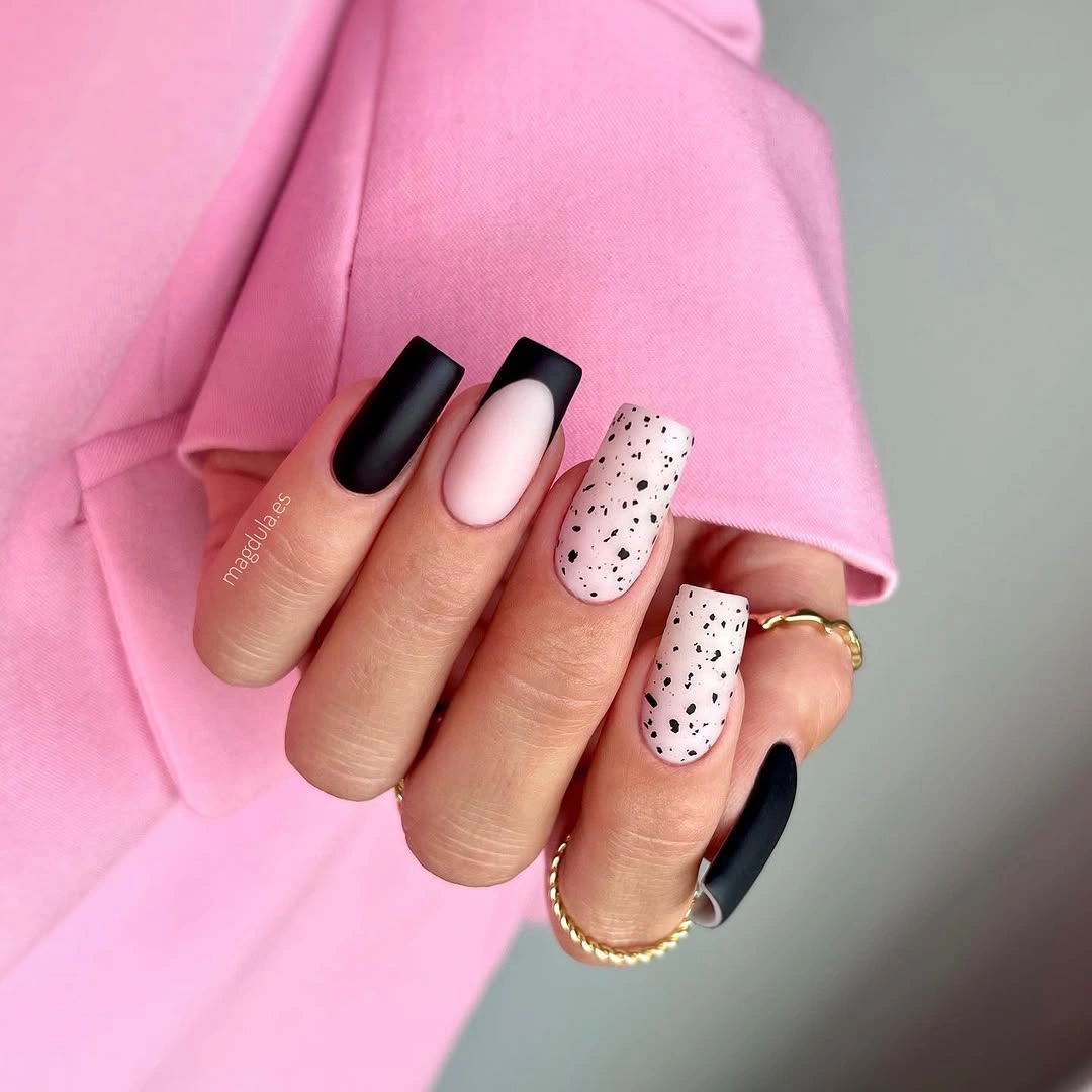 Square black and pale pink nails with white black speckled accent