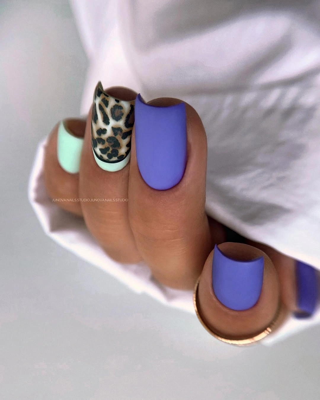 Short violet square nails with mint and leopard print accent
