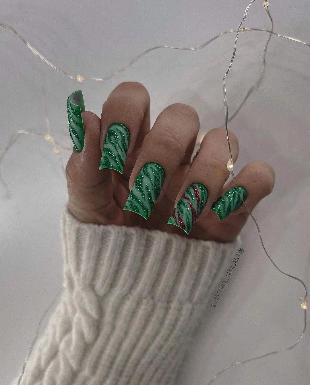 Forest green almond nails with lighter organic green swirl accents