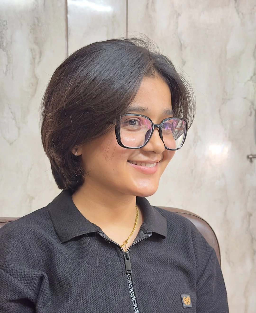 short dark center part bob styled with glasses