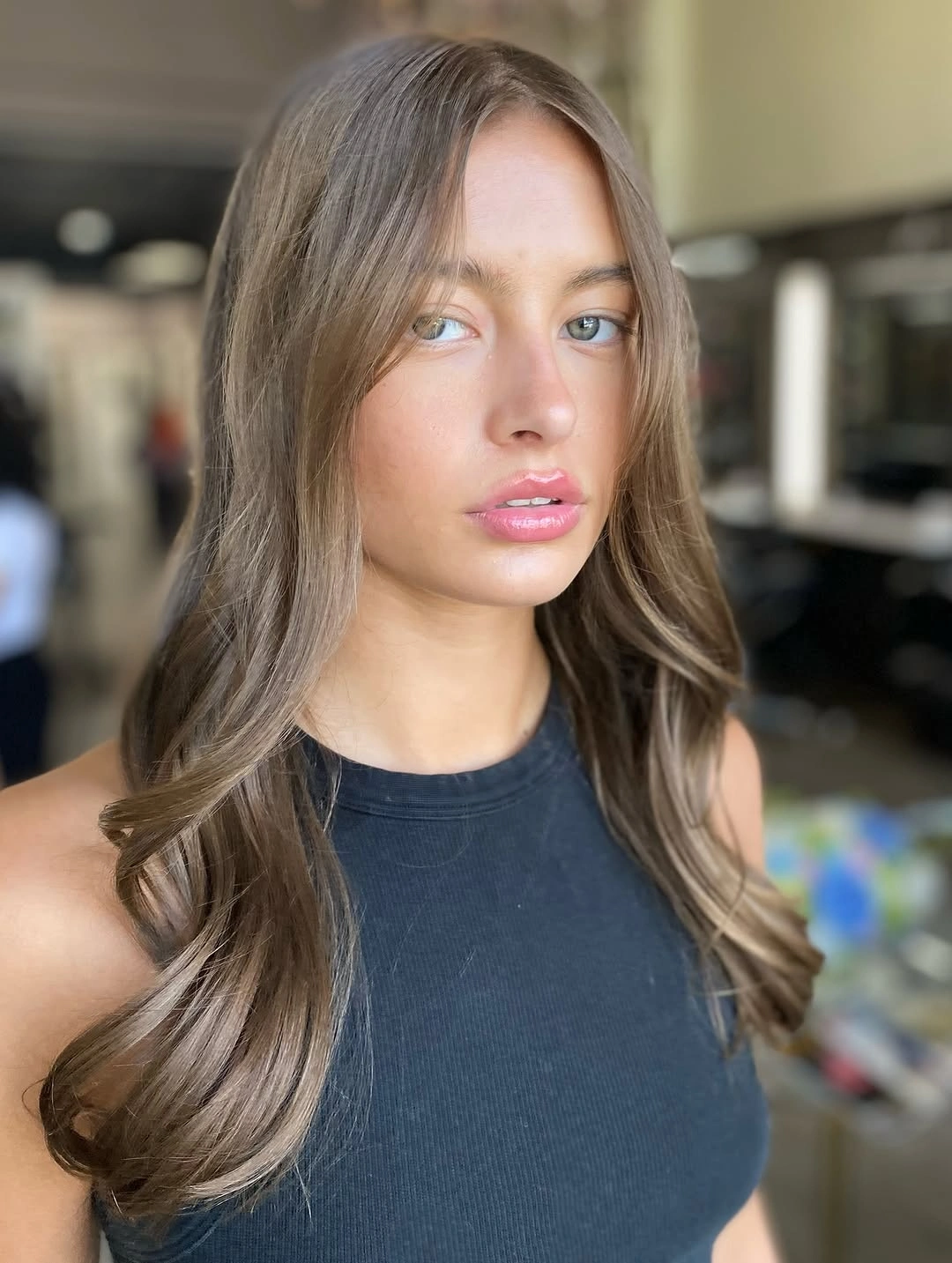 long ash brown waves with a smooth middle part