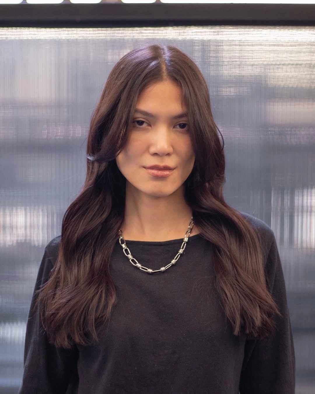 long brunette center part with smooth face framing layers
