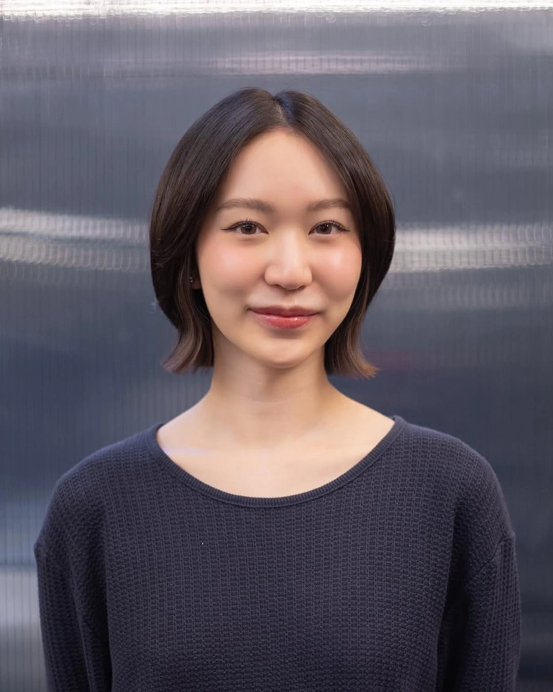 dark rounded bob with a soft middle part