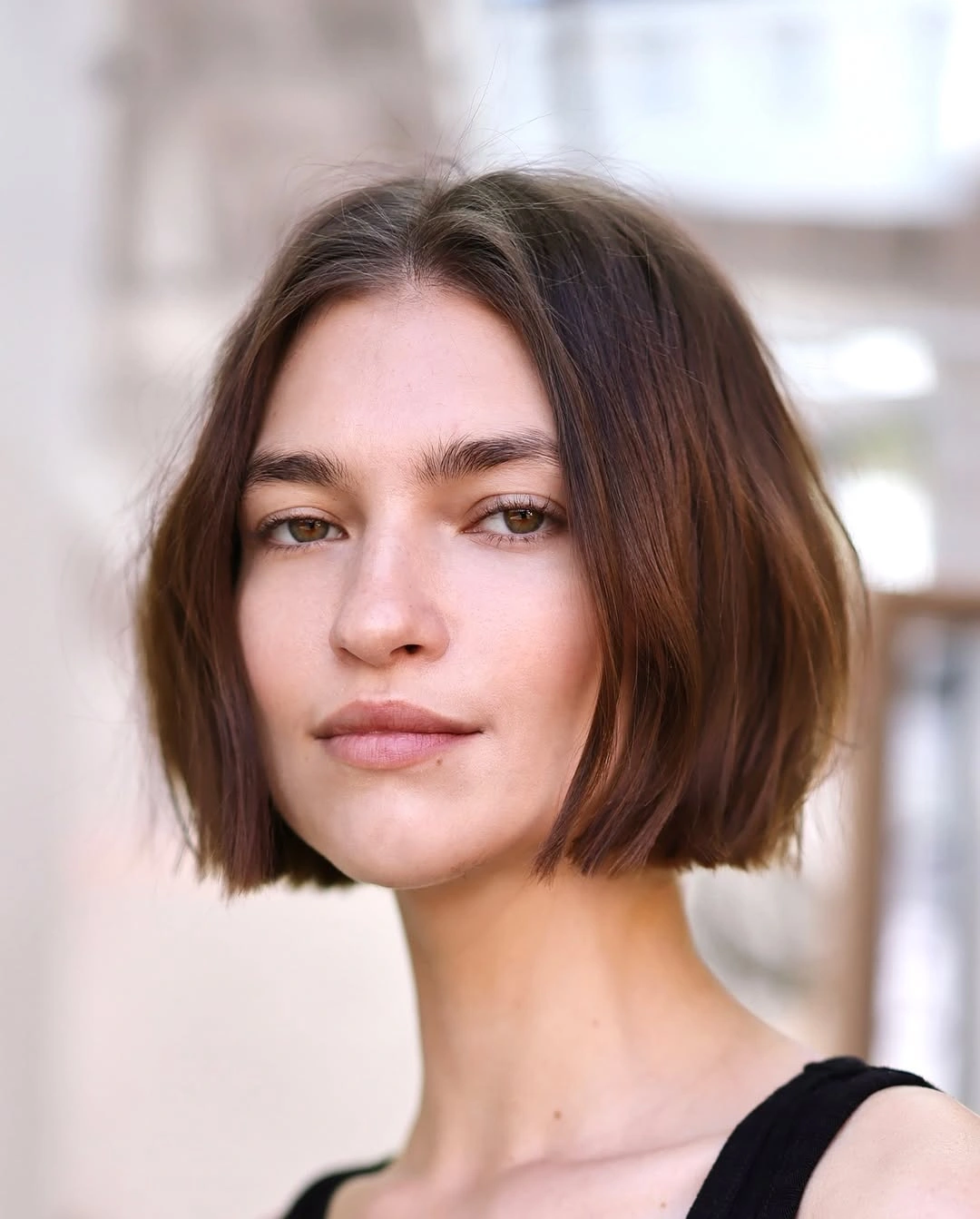 sleek brunette chin bob with clean center part