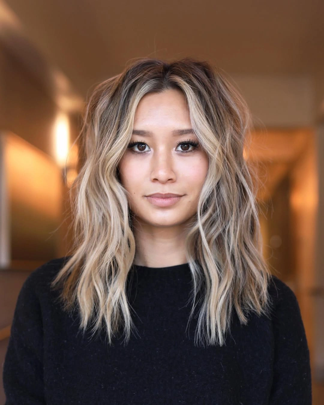 medium blonde waves with bright face framing pieces