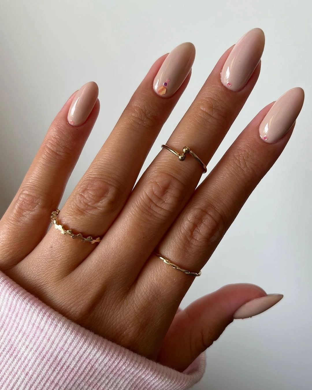 Dusty rose almond nails with tiny light linear accent details