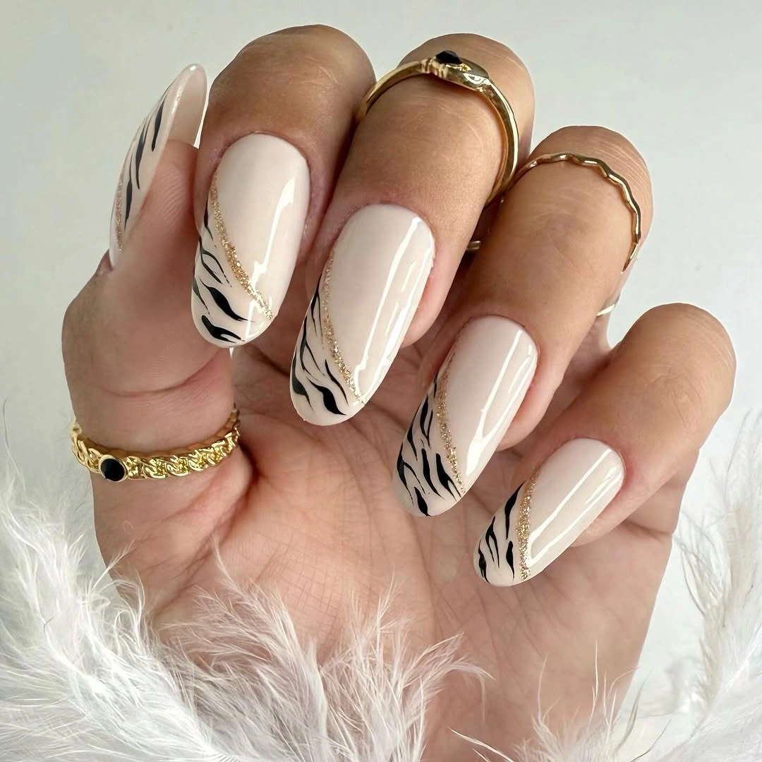 Cream square nails with black botanical and stripe accent details