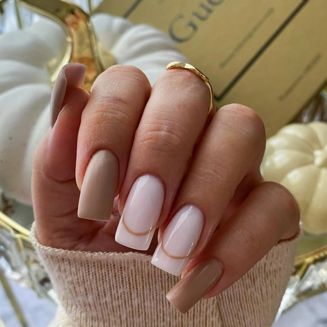 Nude square nails with pale blush blocks and thin white outlines