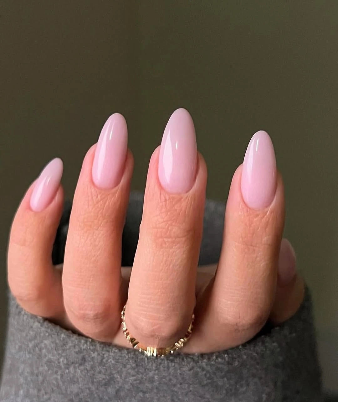Long almond nails in a clean opaque soft pink finish