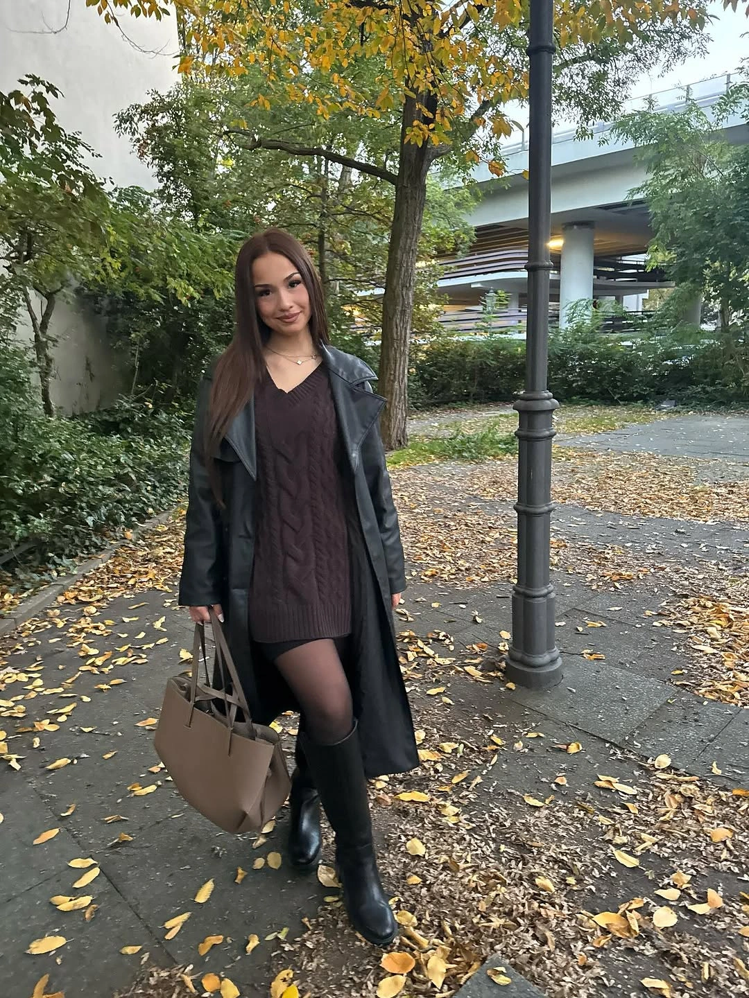 Long black coat with dark tights and ankle boots, carried with large taupe tote