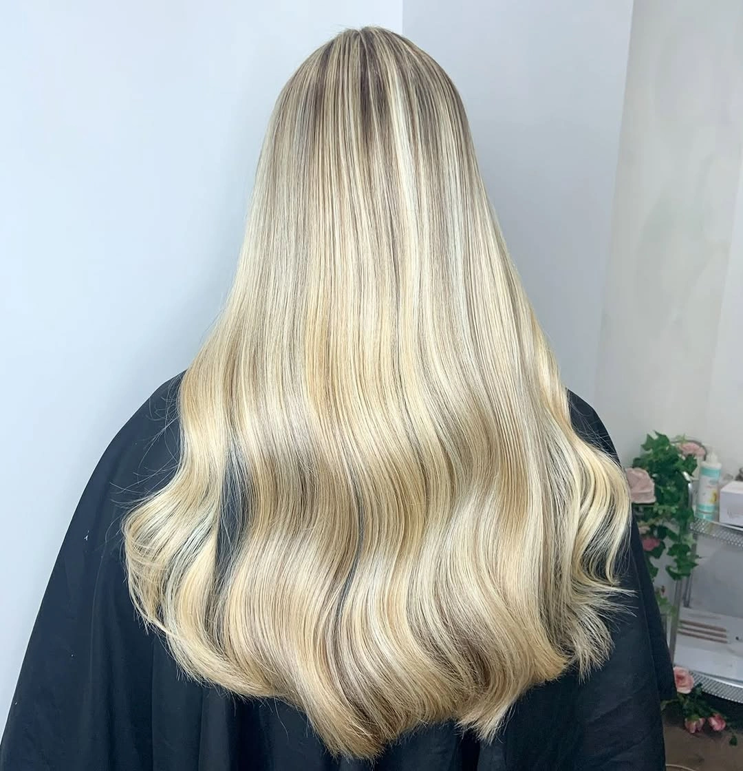 Long pale blonde waves with soft root depth and gently curled broad ends