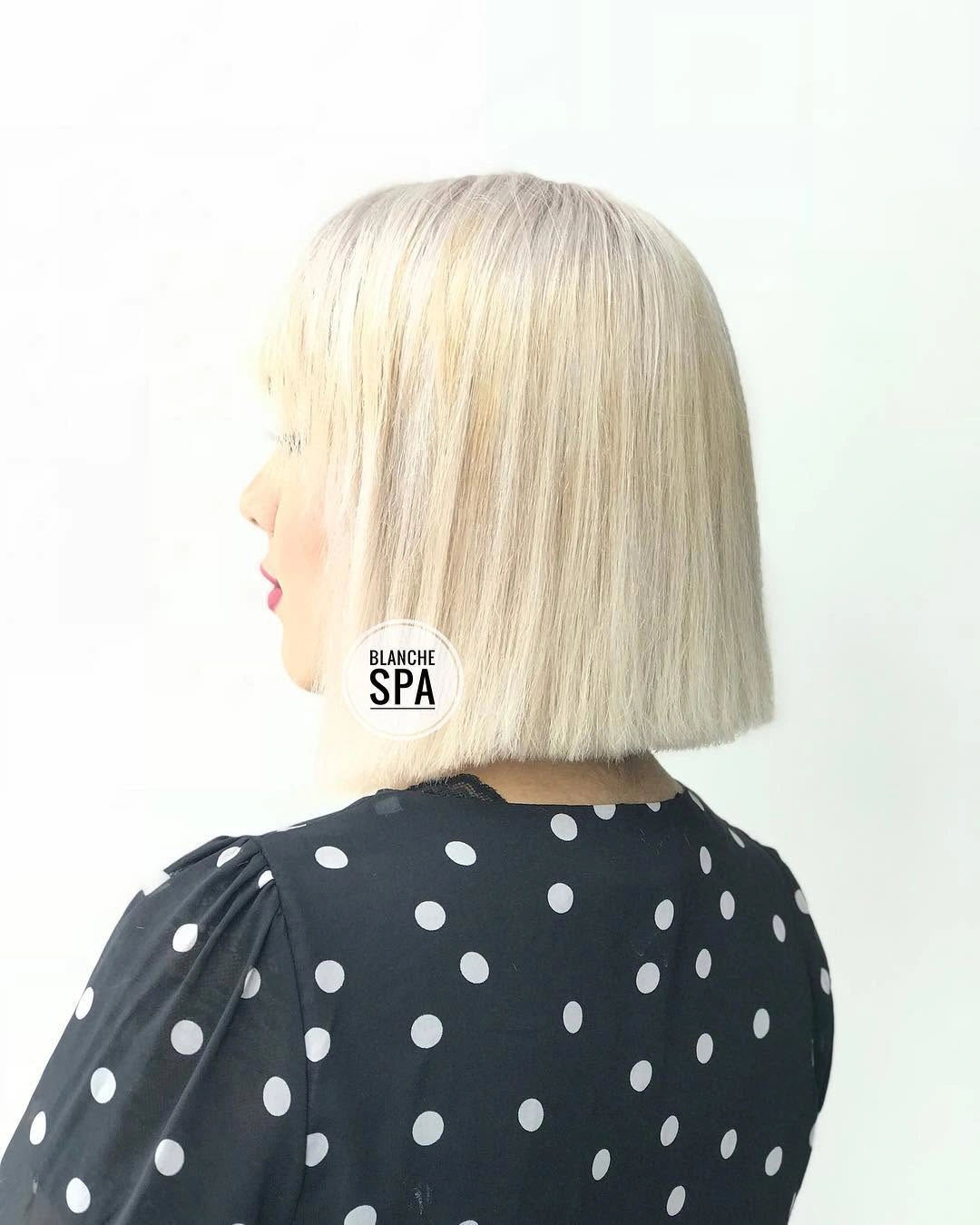 Icy blonde jaw-length blunt bob with short fringe and clean straight perimeter