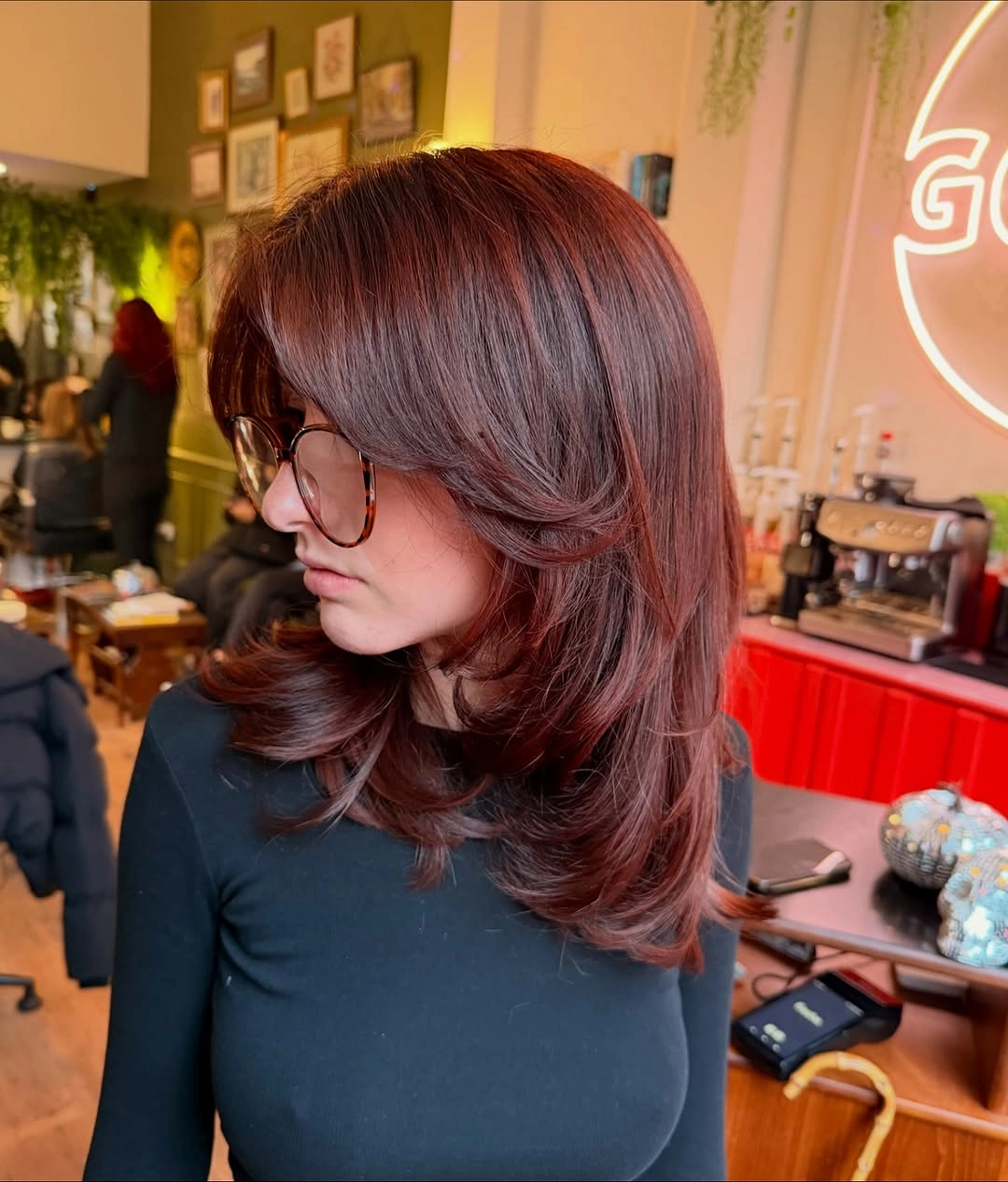 Red-brown shoulder-length shag with long curtain fringe and softly flicked layers