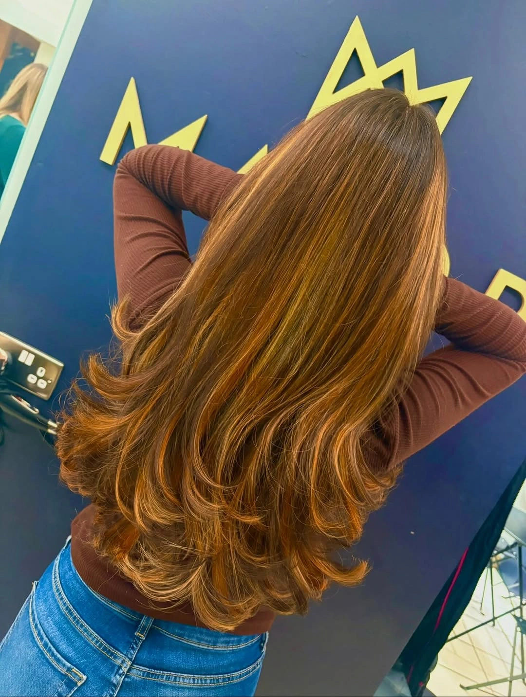 Long honey-brown waves with golden dimension, deeper root, and flowing ends