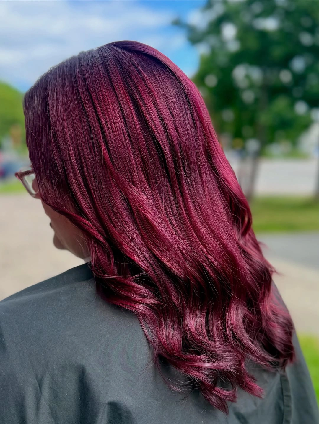 Long plum-red waves with bright berry accents and deeper root area