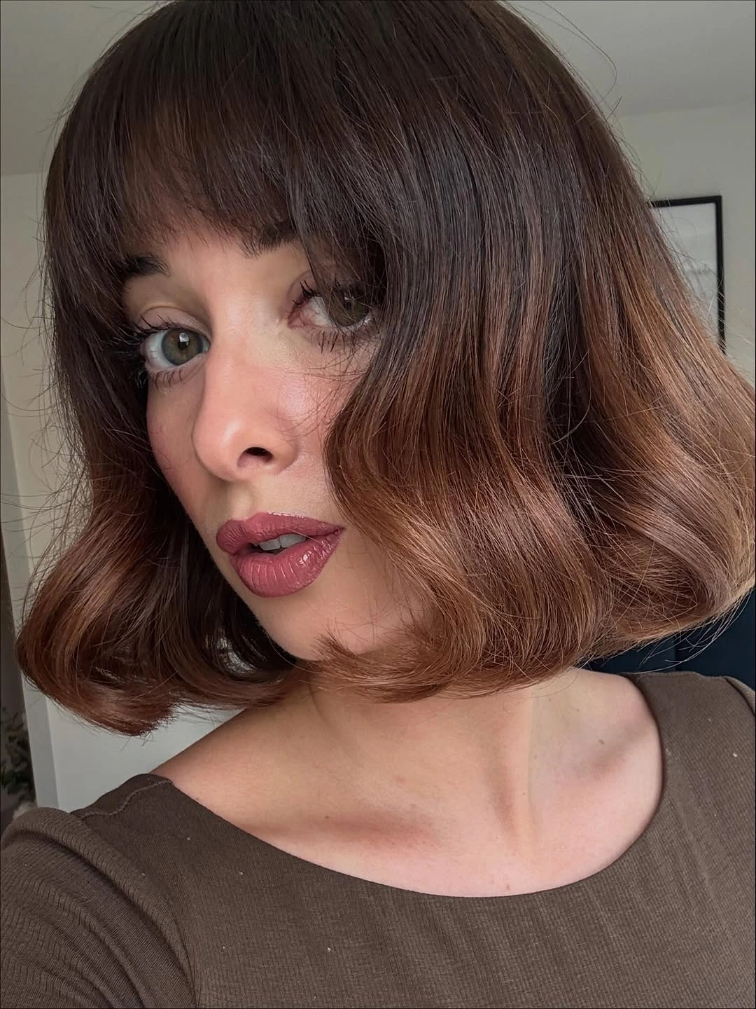 Short rounded brunette bob with full soft fringe and gently bent ends