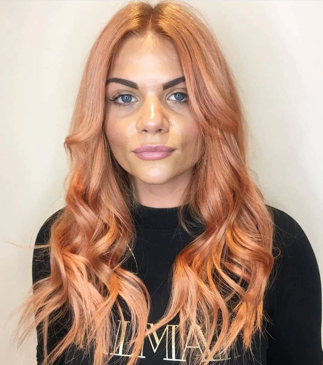 Long peach-copper waves with center part and brighter face-framing front pieces