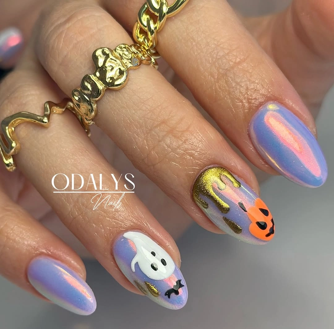 Lavender shimmery nails with small white ghost orange accent and gold drip